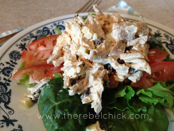 A plate of chicken salad on lettuce leaves.