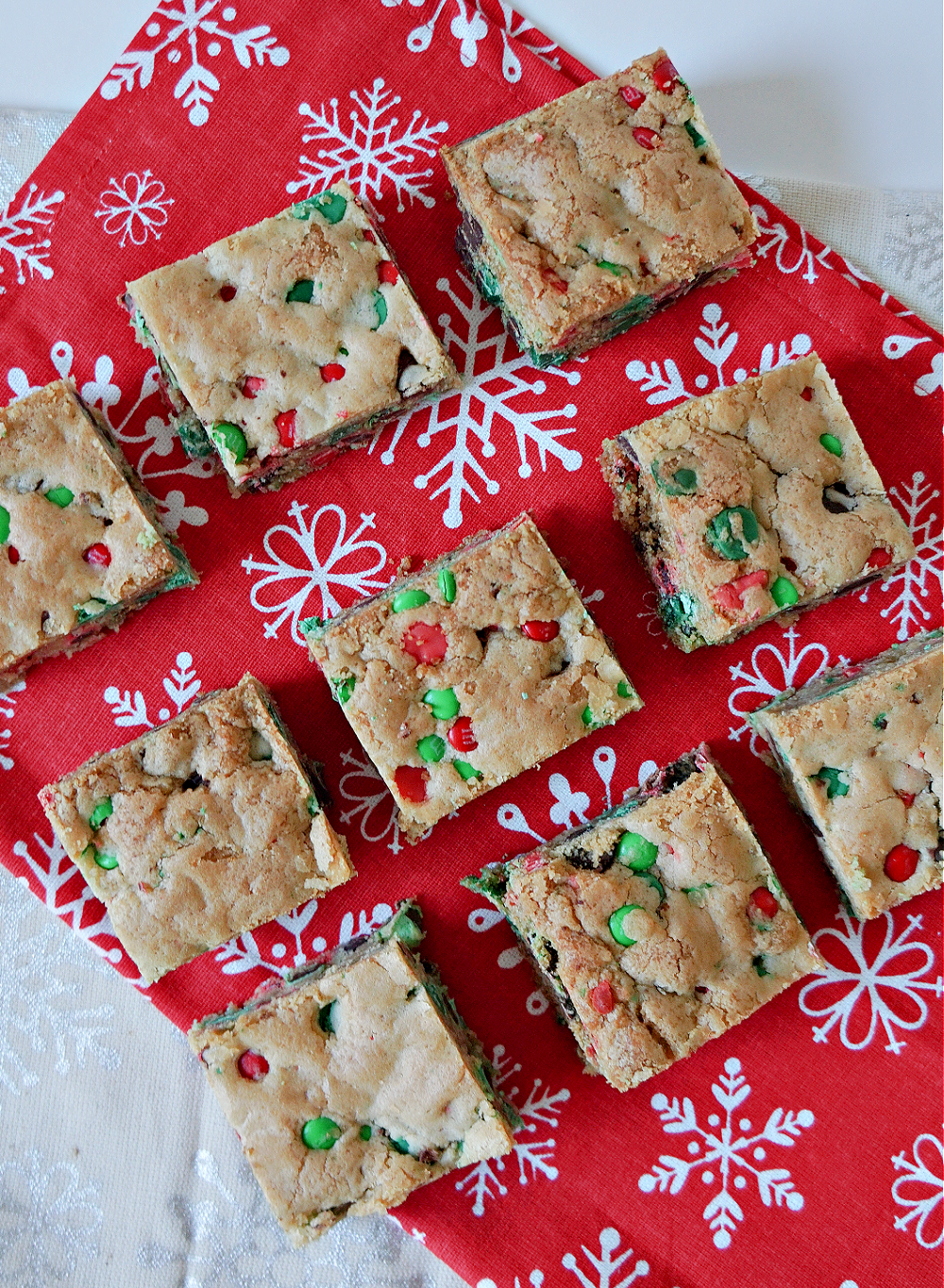 M&Ms Christmas Cookie Bars on a red napkin with red and green M&M candies