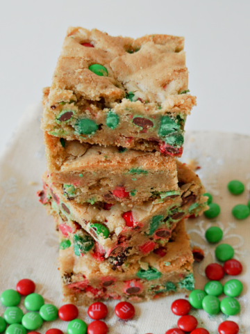 M&Ms Christmas Cookie Bars in a stack with red and green M&M candies