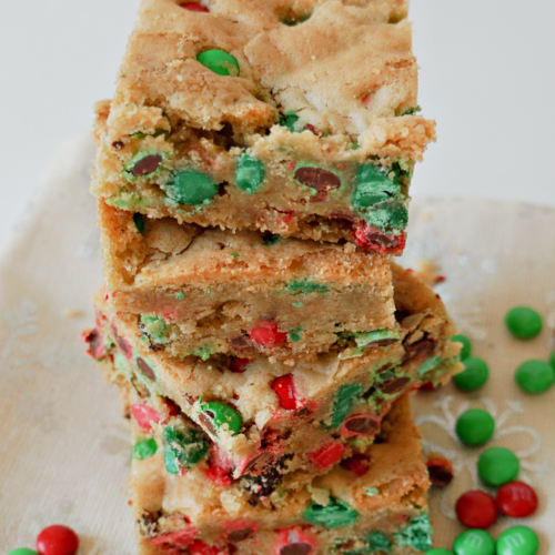 M&Ms Christmas Cookie Bars in a stack with red and green M&M candies