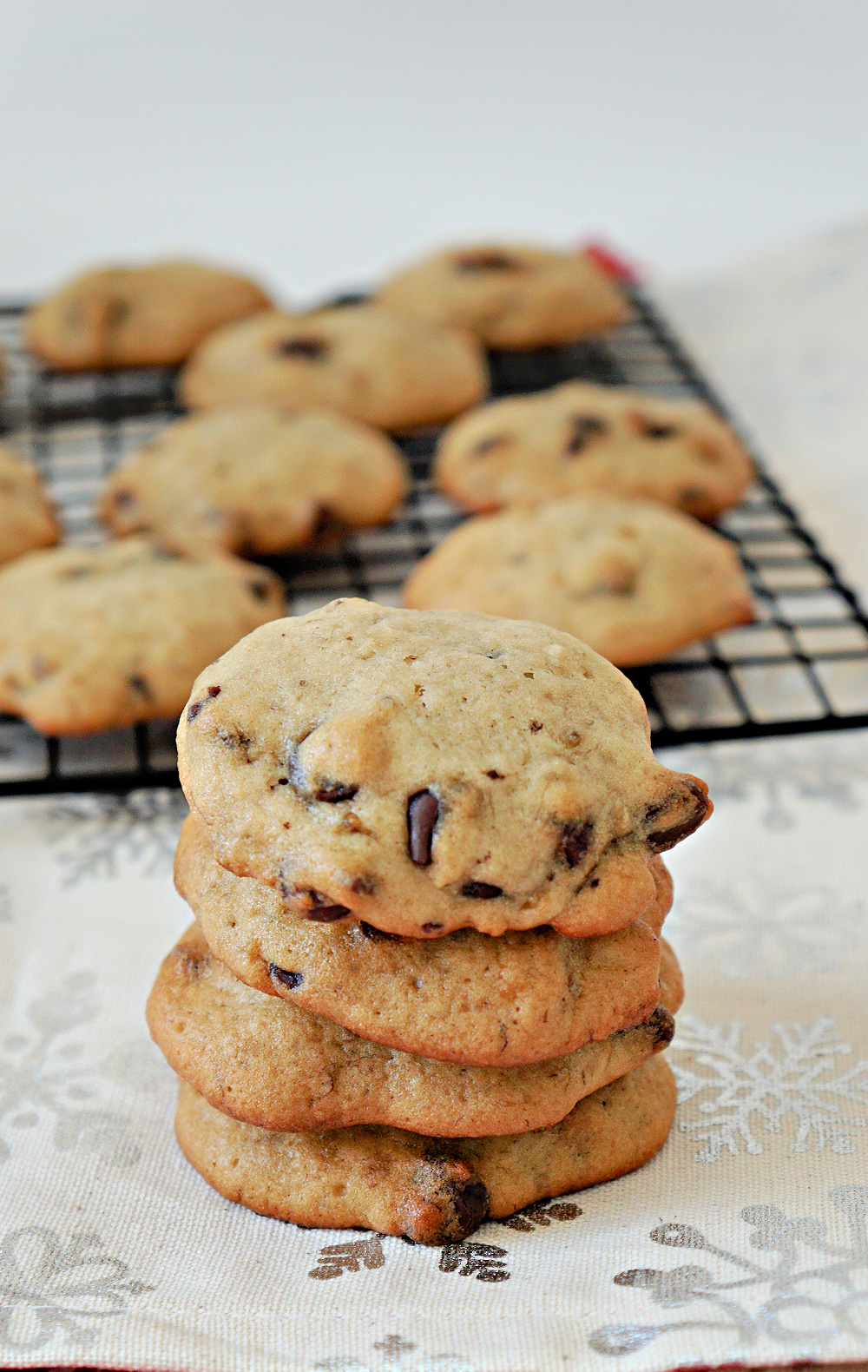golden brown cookies filled with banana and chocolate chips on a wire cooling rack