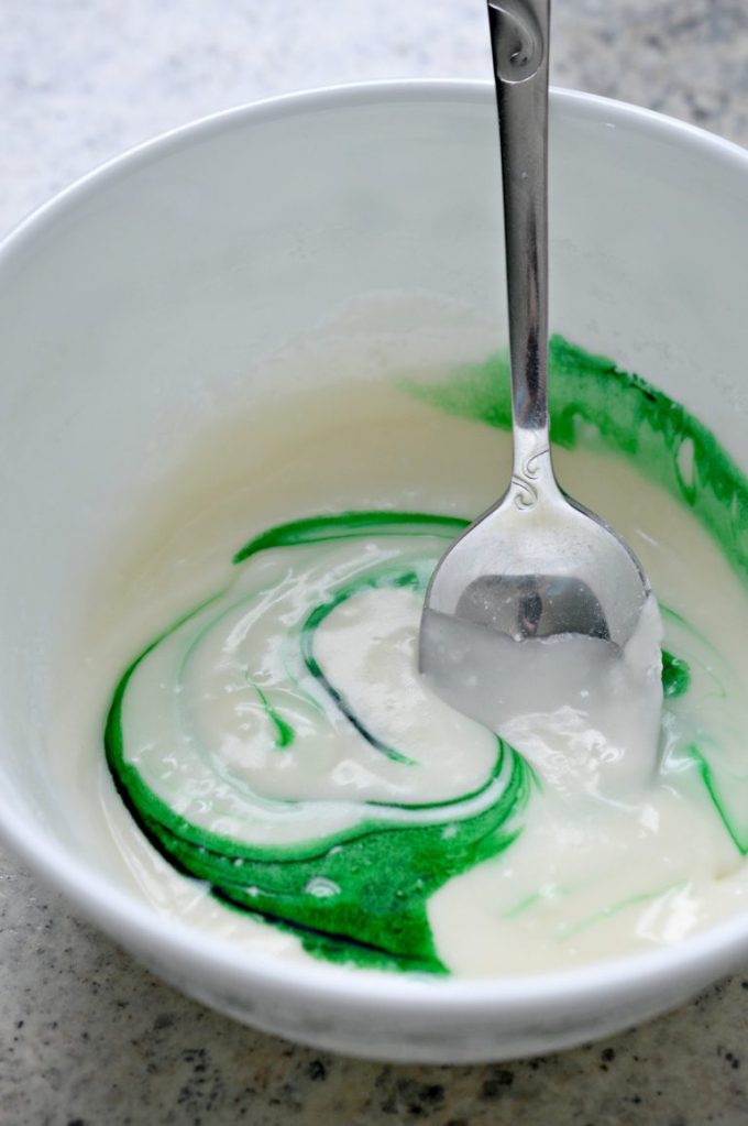 melted butter and sugar in a bowl with green food coloring
