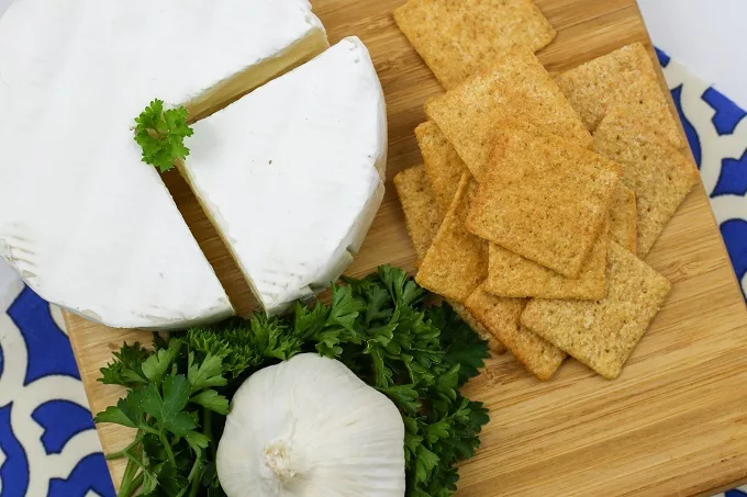 brie wheel and crackers and a bulb of garlic