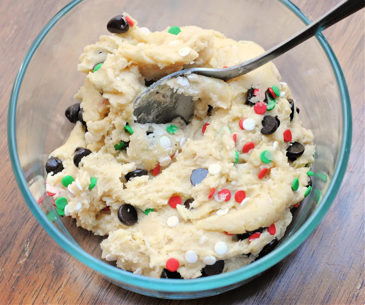 bowl filled with cake batter, chocolate chips and holiday sprinkles