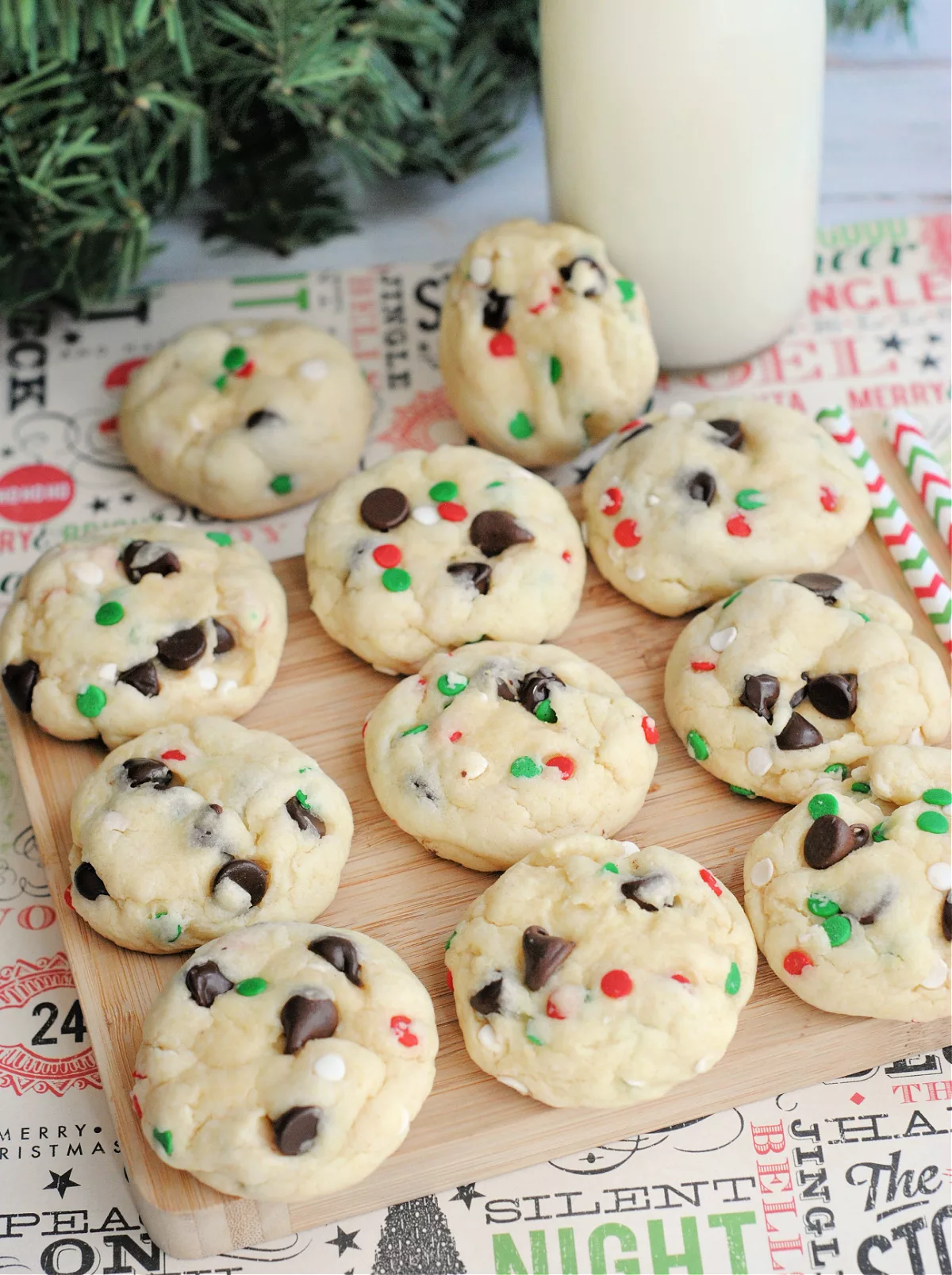 wooden serving board filled with cookies filled with chocolate chips and holiday sprinkles