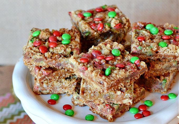 Christmas Caramel Bars with red and green M&Ms stacked on a platter