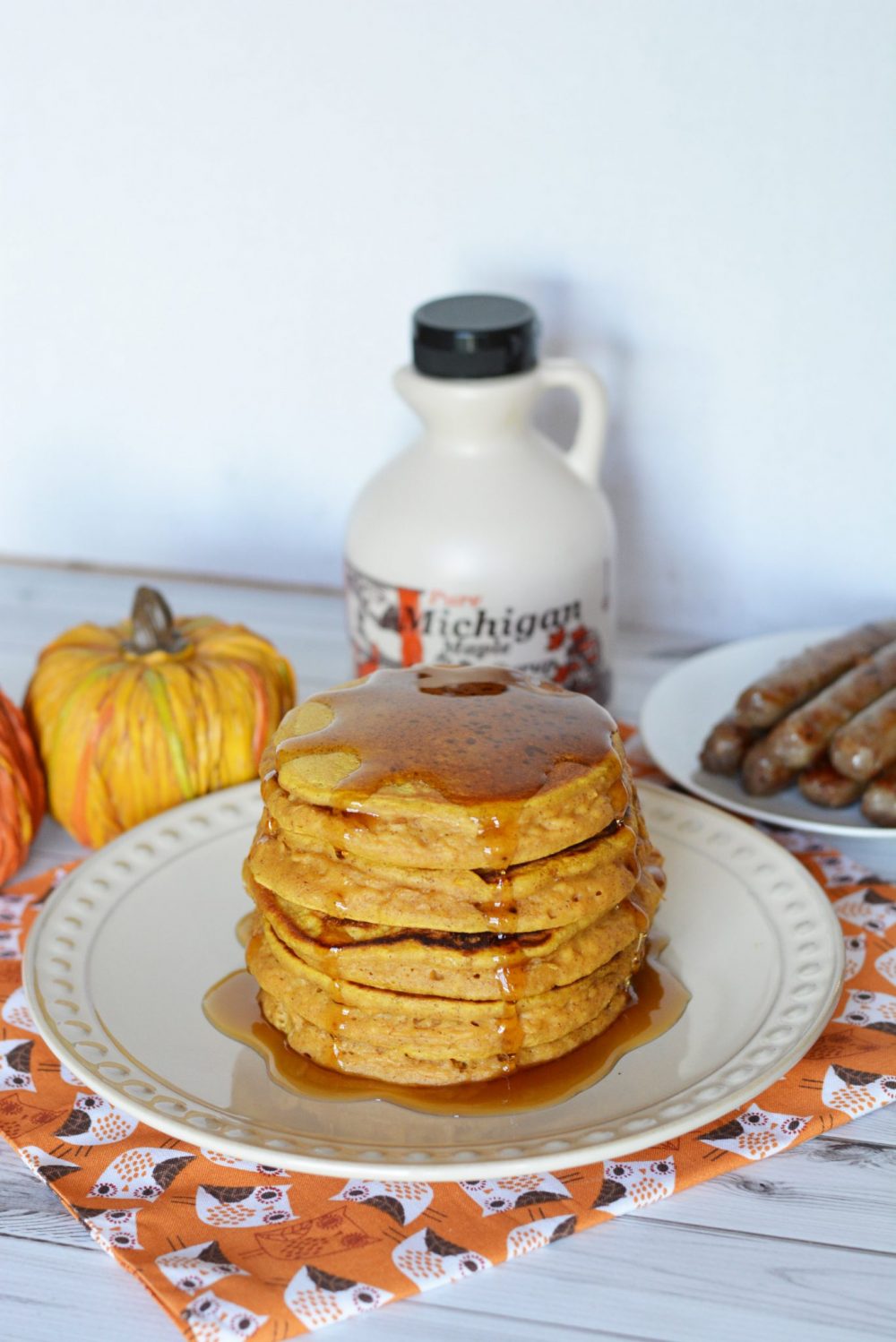Pumpkin Spice Pancakes topped with maple syrup