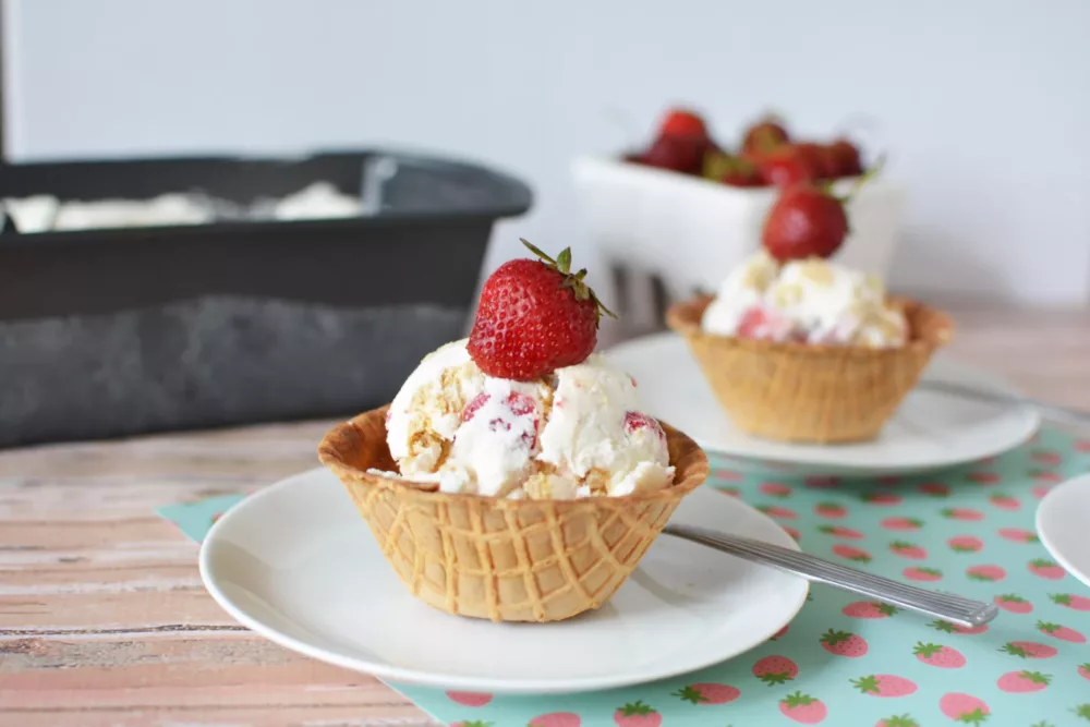 A waffle bowl of strawberry cheesecake ice cream.