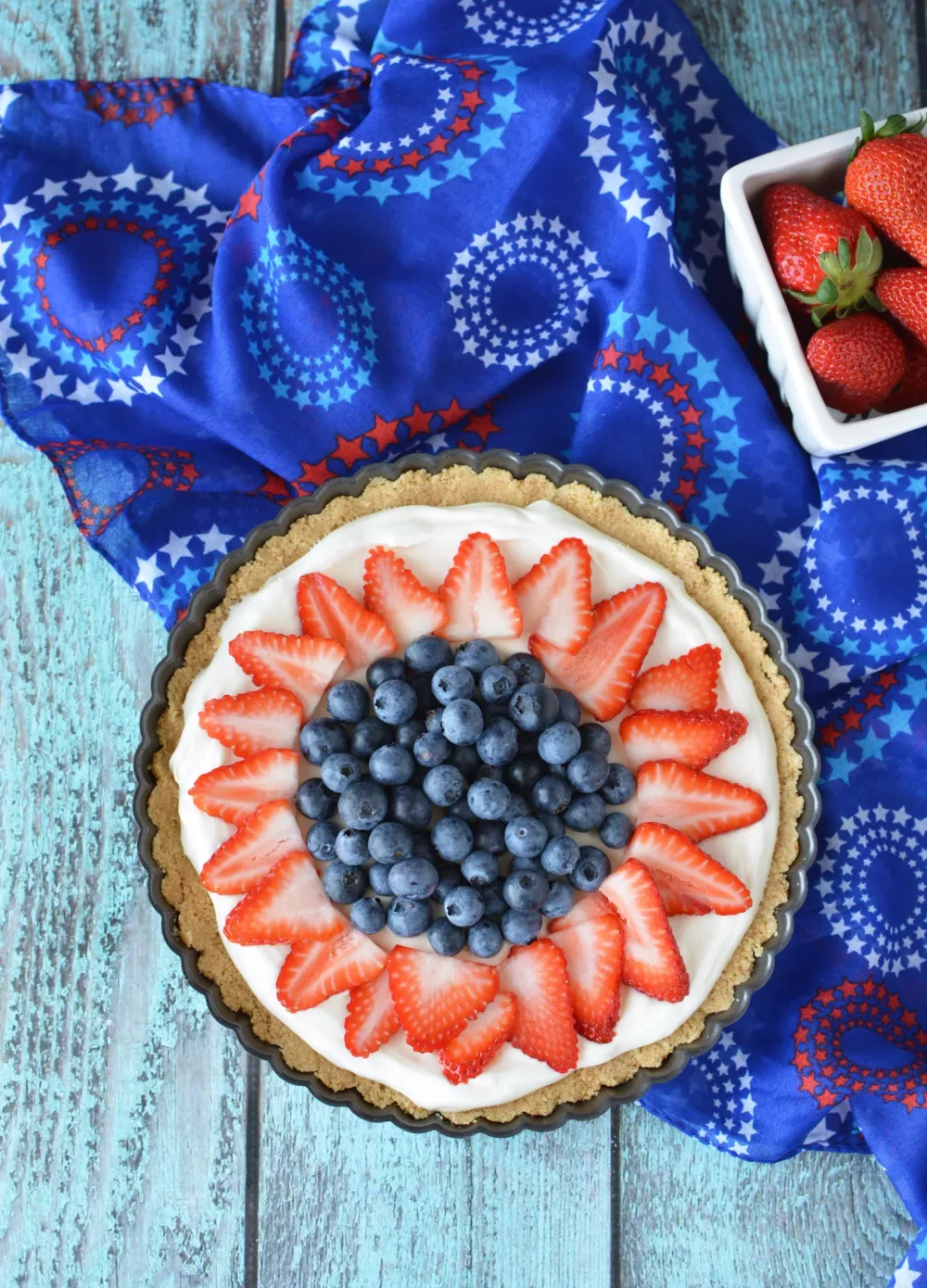 Strawberry Blueberry Tart filled with cream cheese filling and decorated with blueberries and strawberries