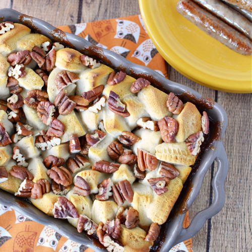 casserole dish filled with apples, pecans on a doughy filling