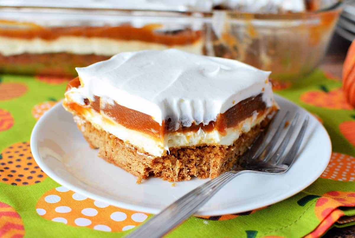 Cream Cheese Pumpkin Dessert on a white plate with a festive fall background