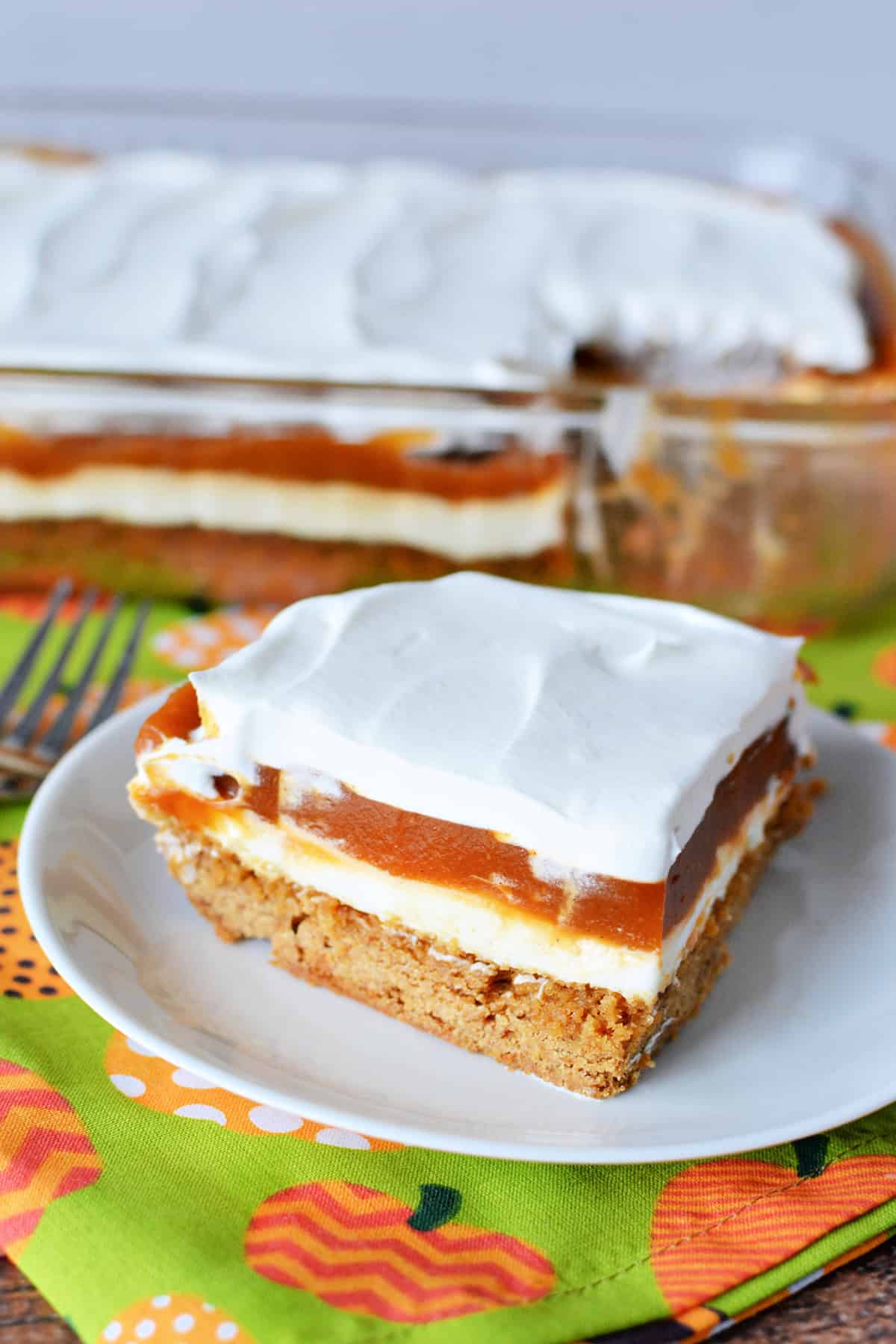 Cream Cheese Pumpkin Dessert on a white plate with a festive fall background