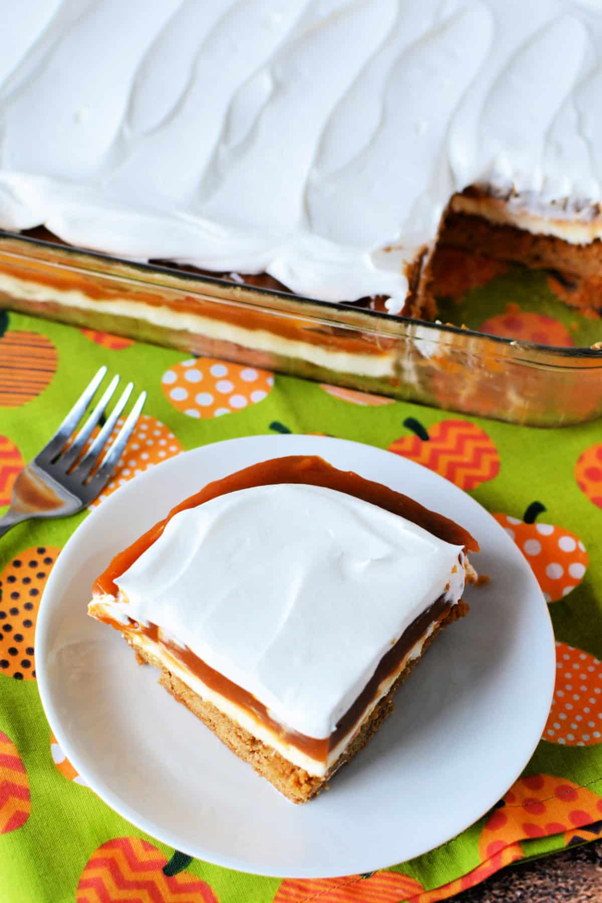 Cream Cheese Pumpkin Dessert on a white plate with a festive fall background