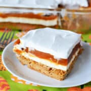 Cream Cheese Pumpkin Dessert on a white plate with a festive fall background