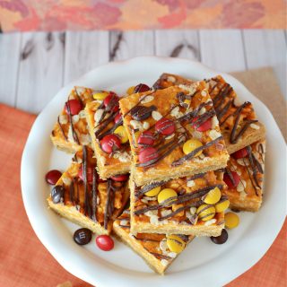 Pumpkin bars filled with spice, chocolate candies, and drizzled with chocolate