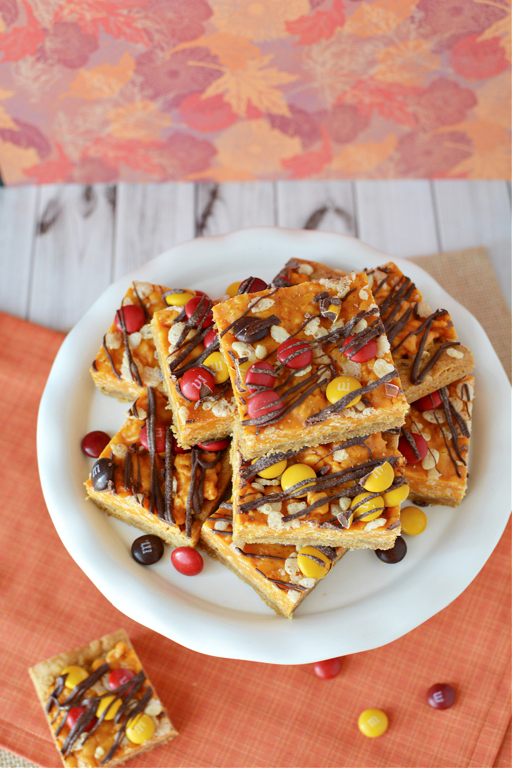 Pumpkin bars filled with spice, chocolate candies, and drizzled with chocolate 