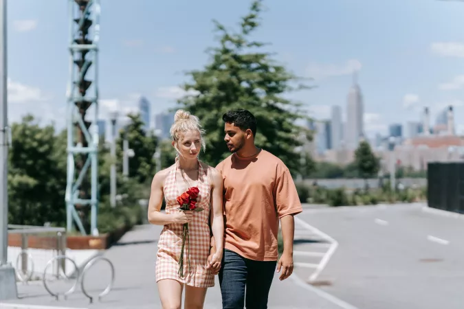 couple walking with a red rose