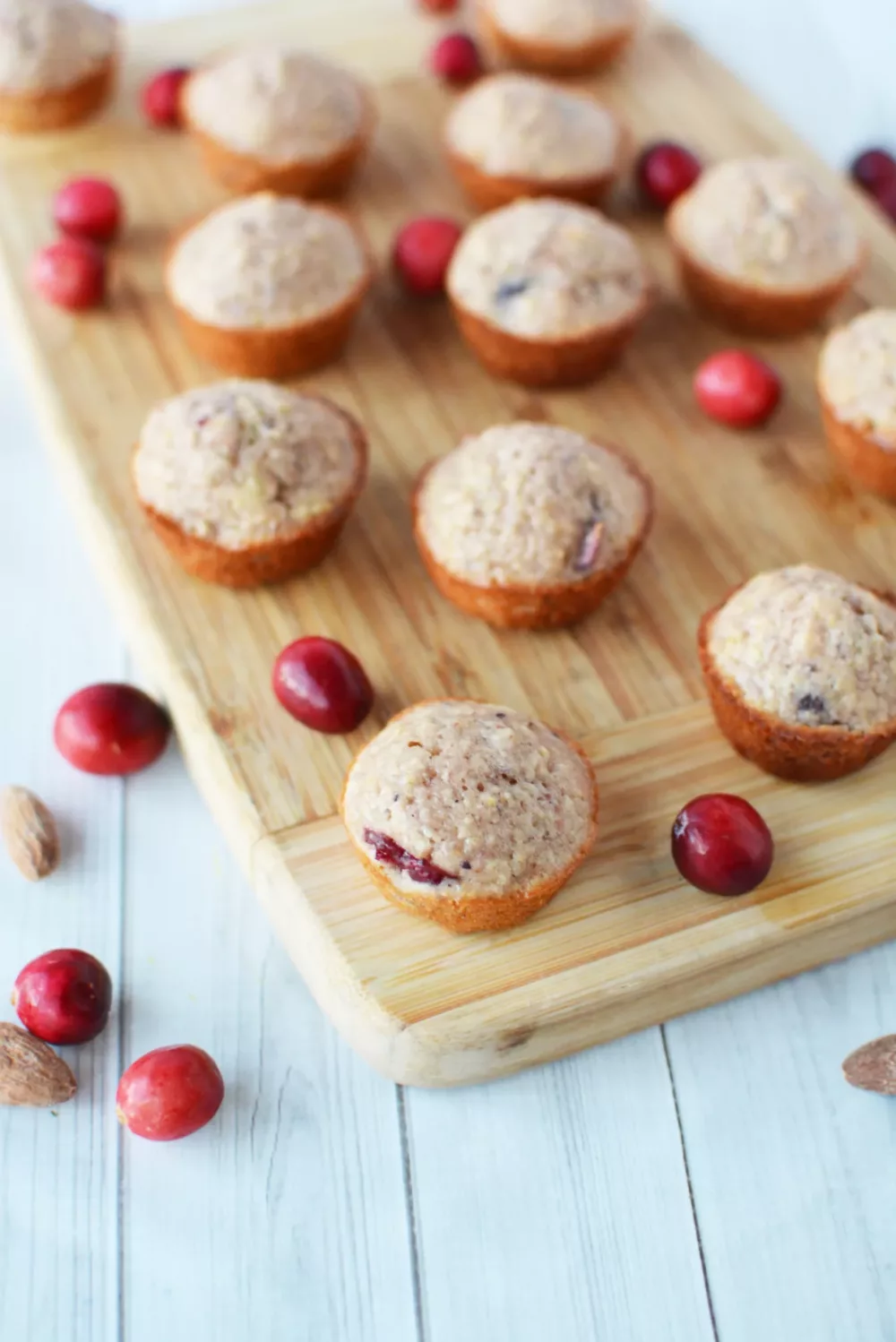 Cranberry Almond Mini Muffins on a wooden cutting board
