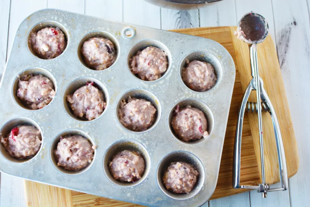 Cranberry Almond Muffin batter in a mini muffin pan