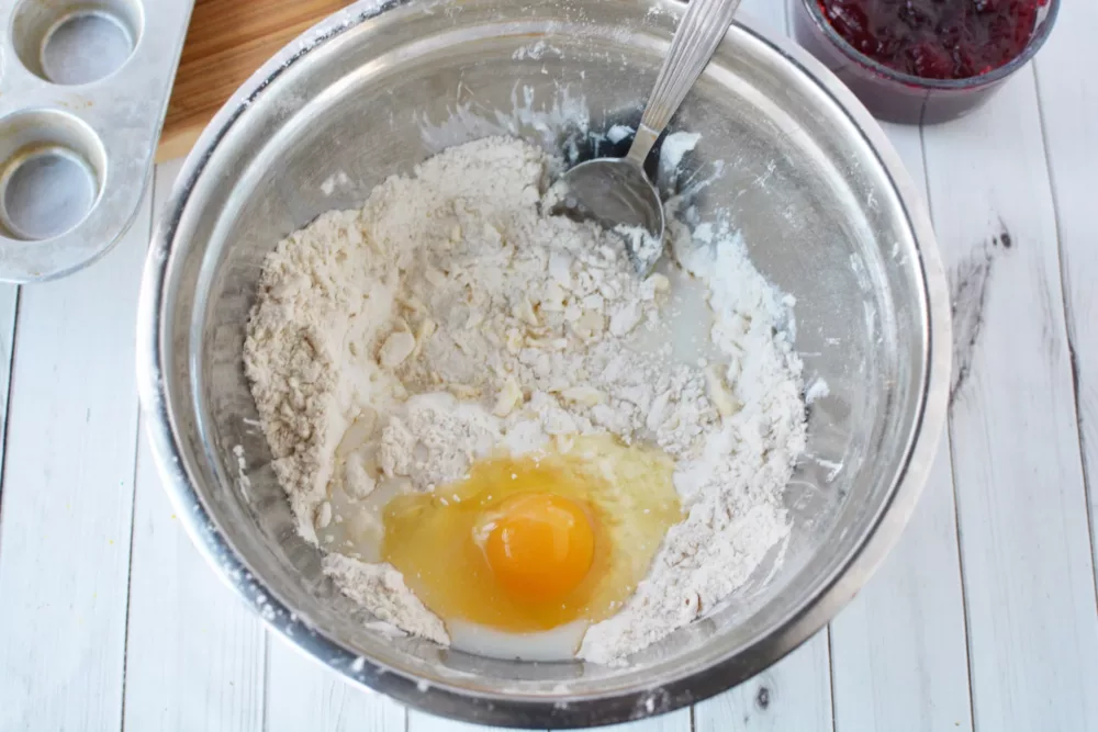 egg in a bowl with flour and butter