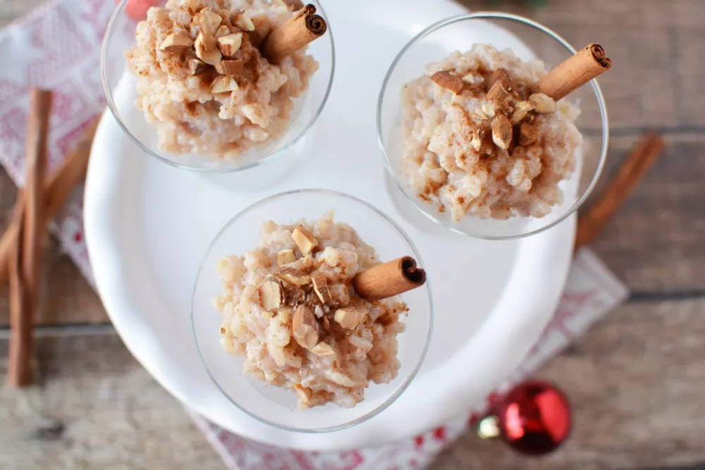 Rice Pudding in fancy glasses topped with a cinnamon stick