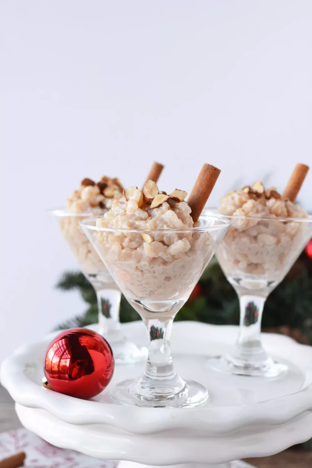 Rice Pudding in fancy glasses topped with a cinnamon stick