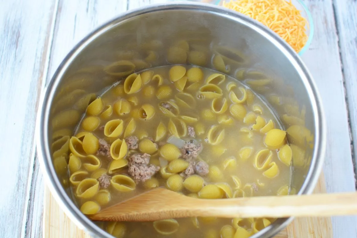 Add pasta, chicken broth and water to the pot.