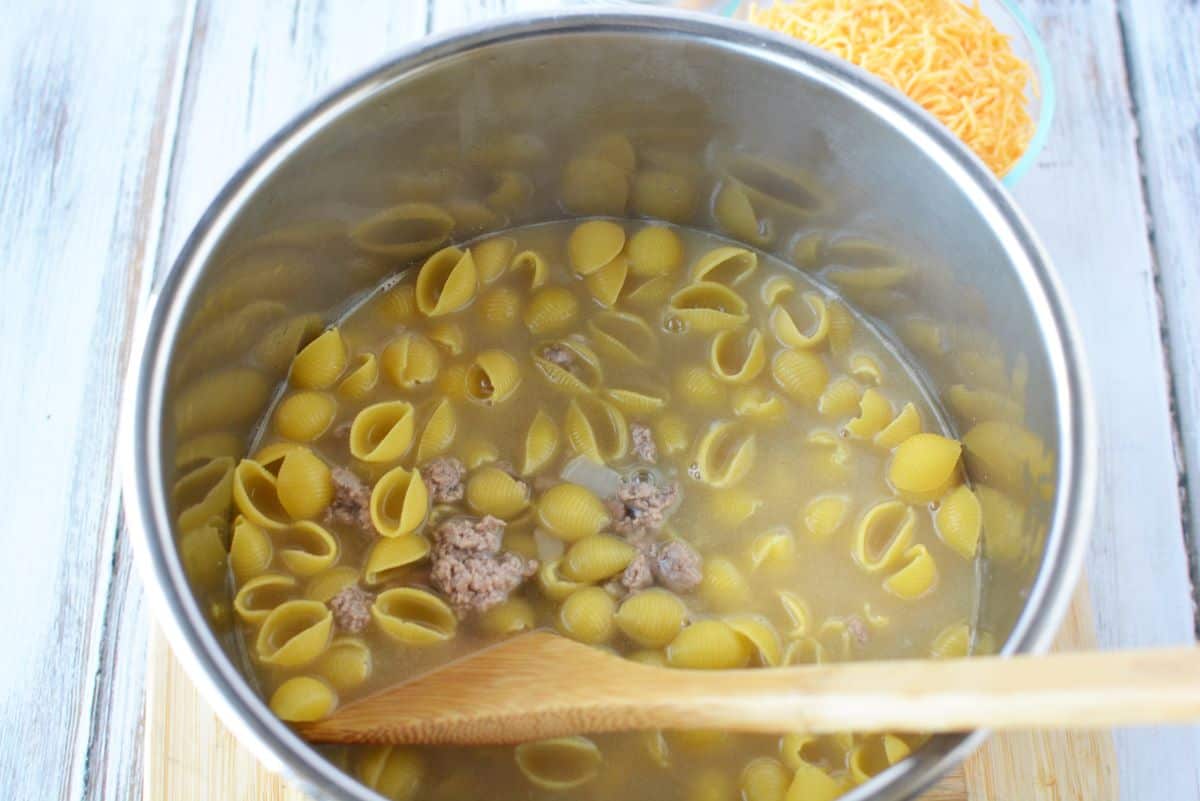 Add pasta, chicken broth and water to the pot.