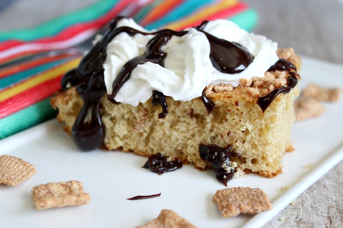 A slice of dessert made with cinnamon toast crunch cereal and topped with hot fudge sauce