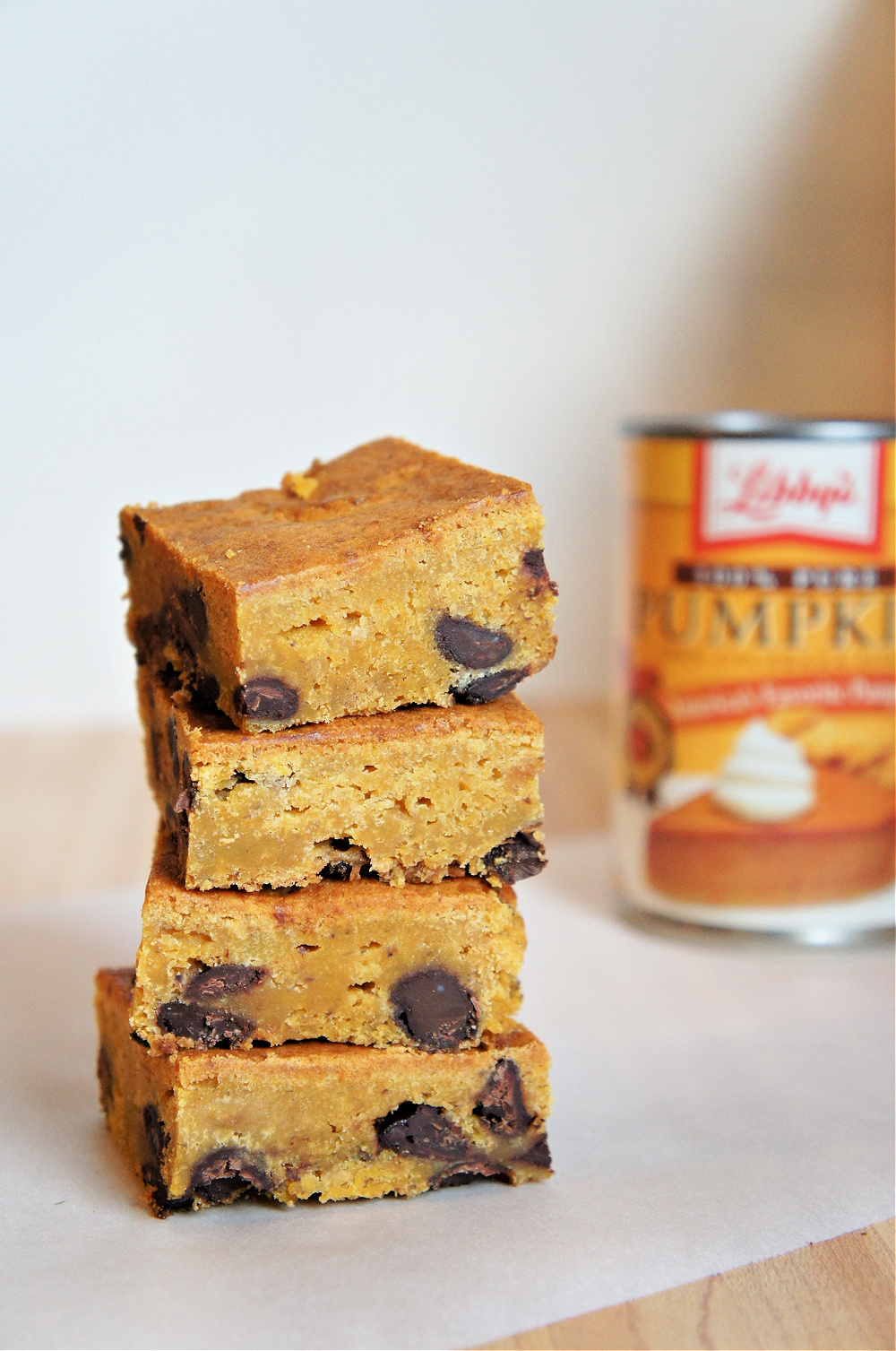 a stack of pumpkin bars filled with chocolate chips with Libbys pumpkin can in the background