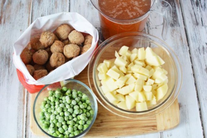 bowls of frozen peas, broth, potatoes and frozen meatballs