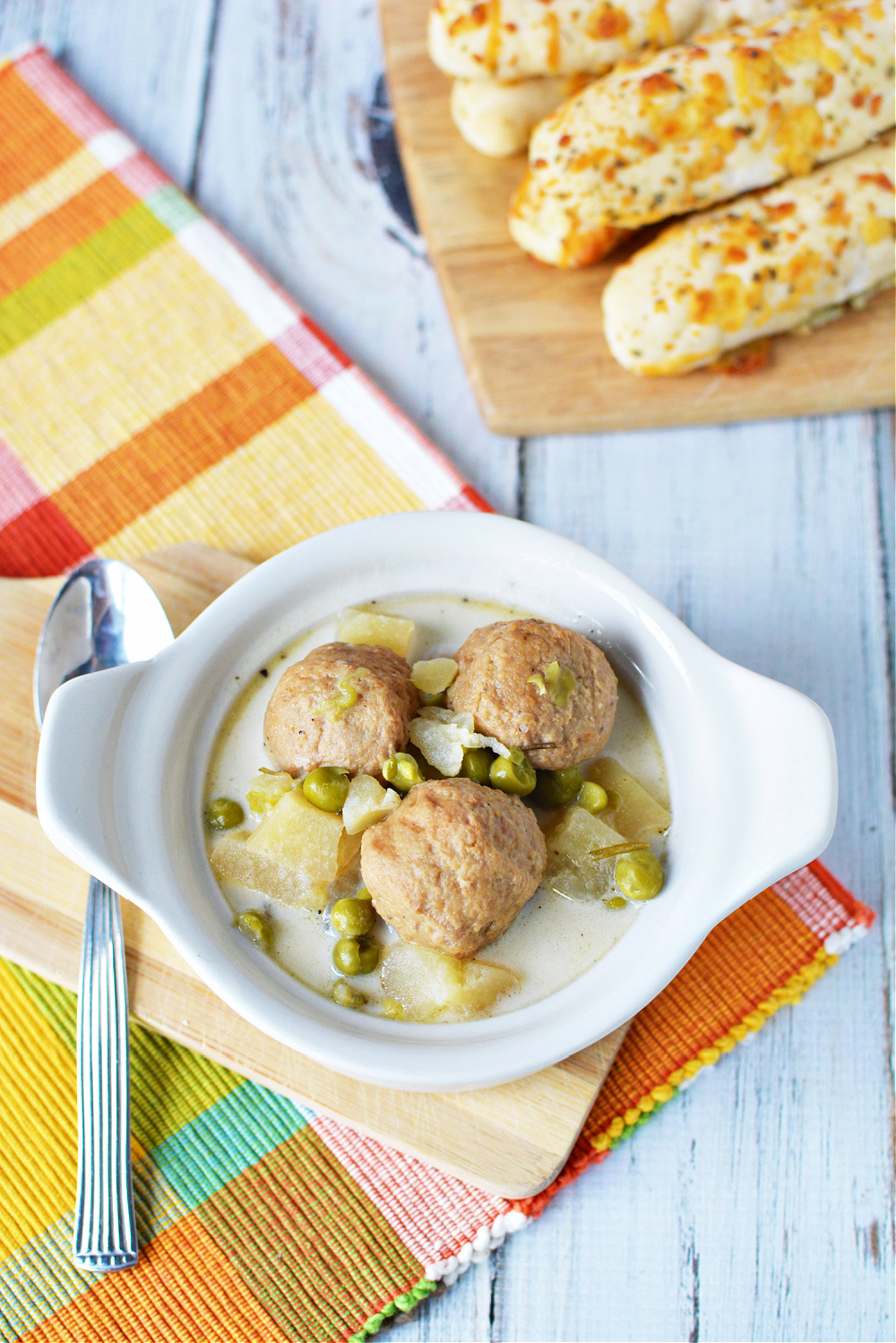Swedish Meatball soup in a bowl with peas and potatoes