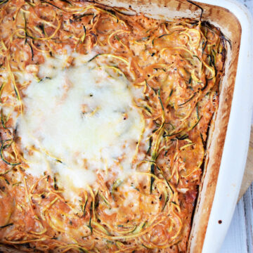 spiralized zucchini in a casserole with melted cheese on top