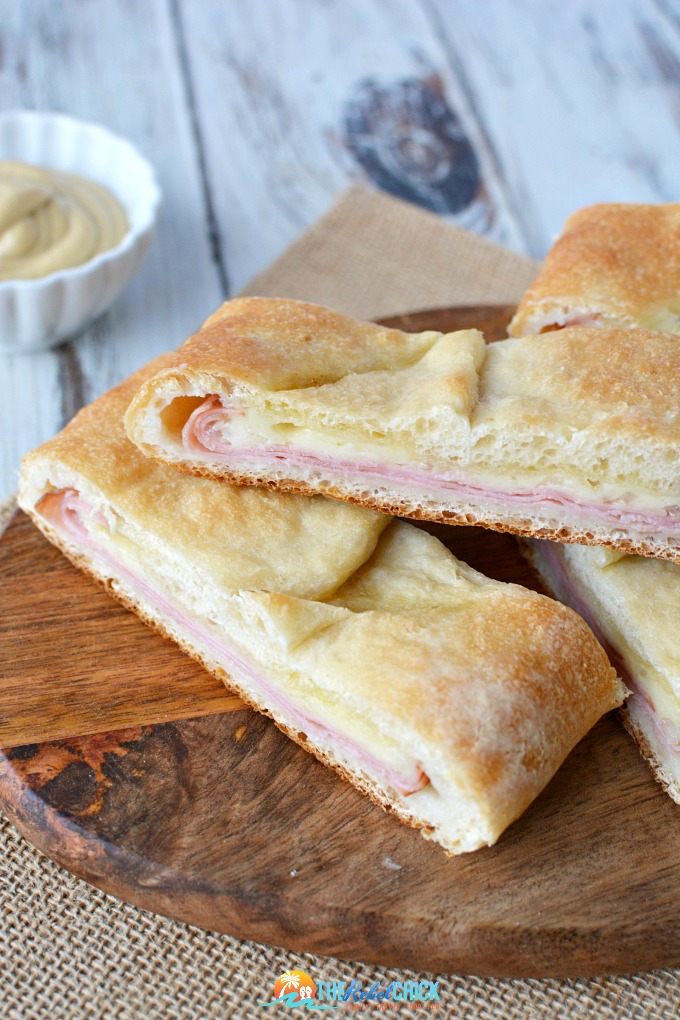 Ham and Cheese Stromboli on a wooden cutting board