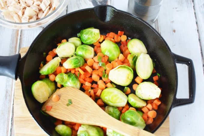 Chicken, carrots and Brussel Sprouts in a cast iron skillet