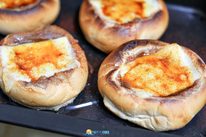 Bread bowls filled with french onion soup.