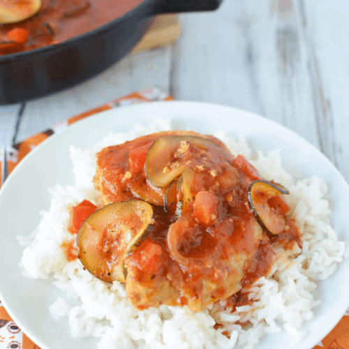 Italian Style Pork Chops with tomato sauce over a bed of white rice