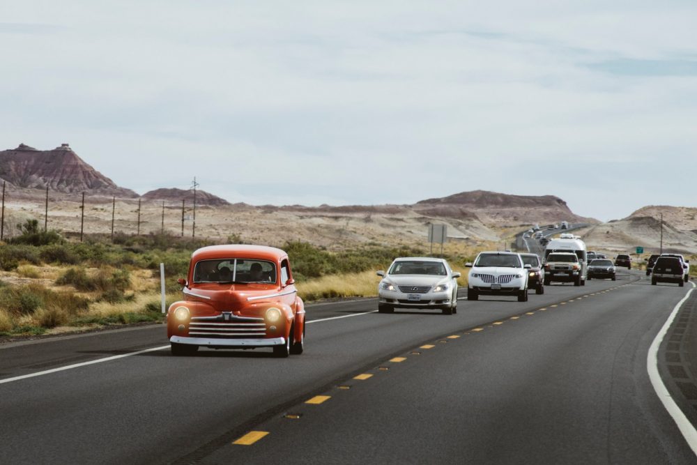 classic cars on a scenic highway