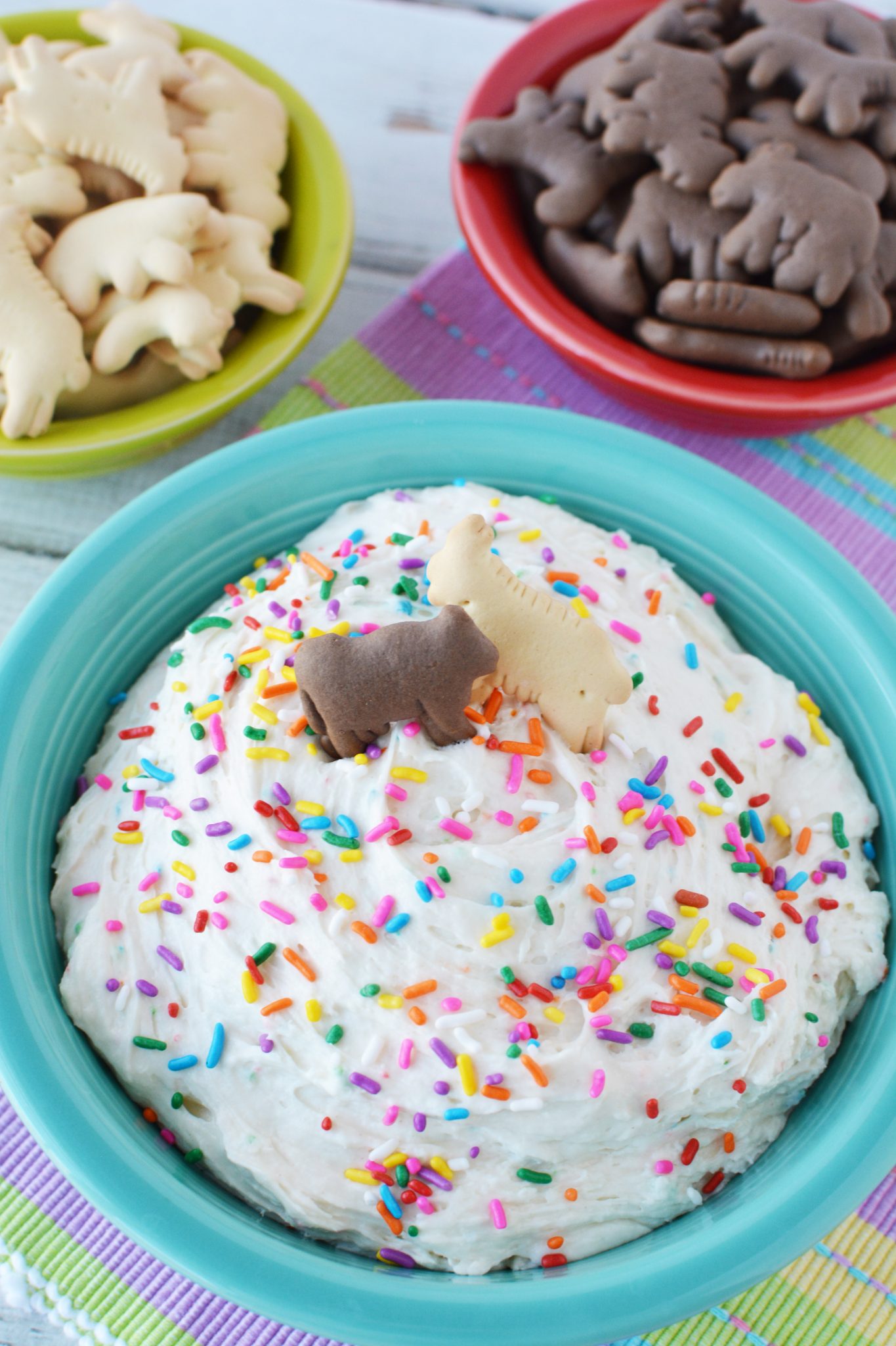 fluffy funfetti dip covered in sprinkles and graham cracker cookies for dipping