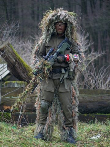 man playing airsoft in full camo