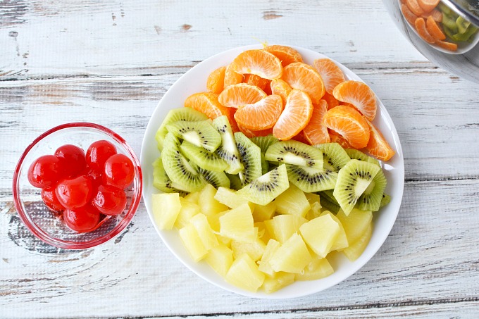 bowl of maraschino cherries, mandarin oranges, kiwi and pineapple