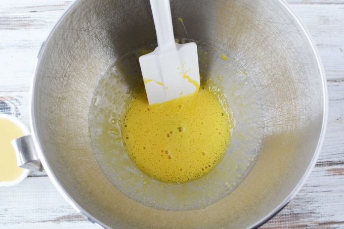 Beaten egg yolks in a mixing bowl 