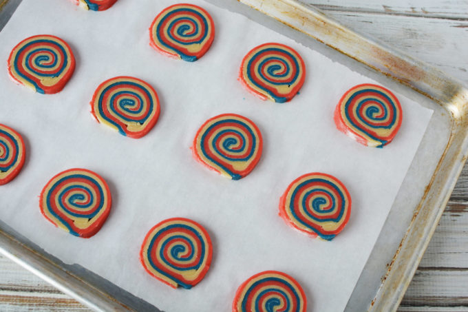 pinwheel cookies on a cookie sheet lined with parchment paper