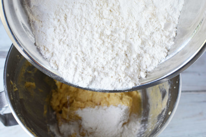 flour being poured into a mixing bowl