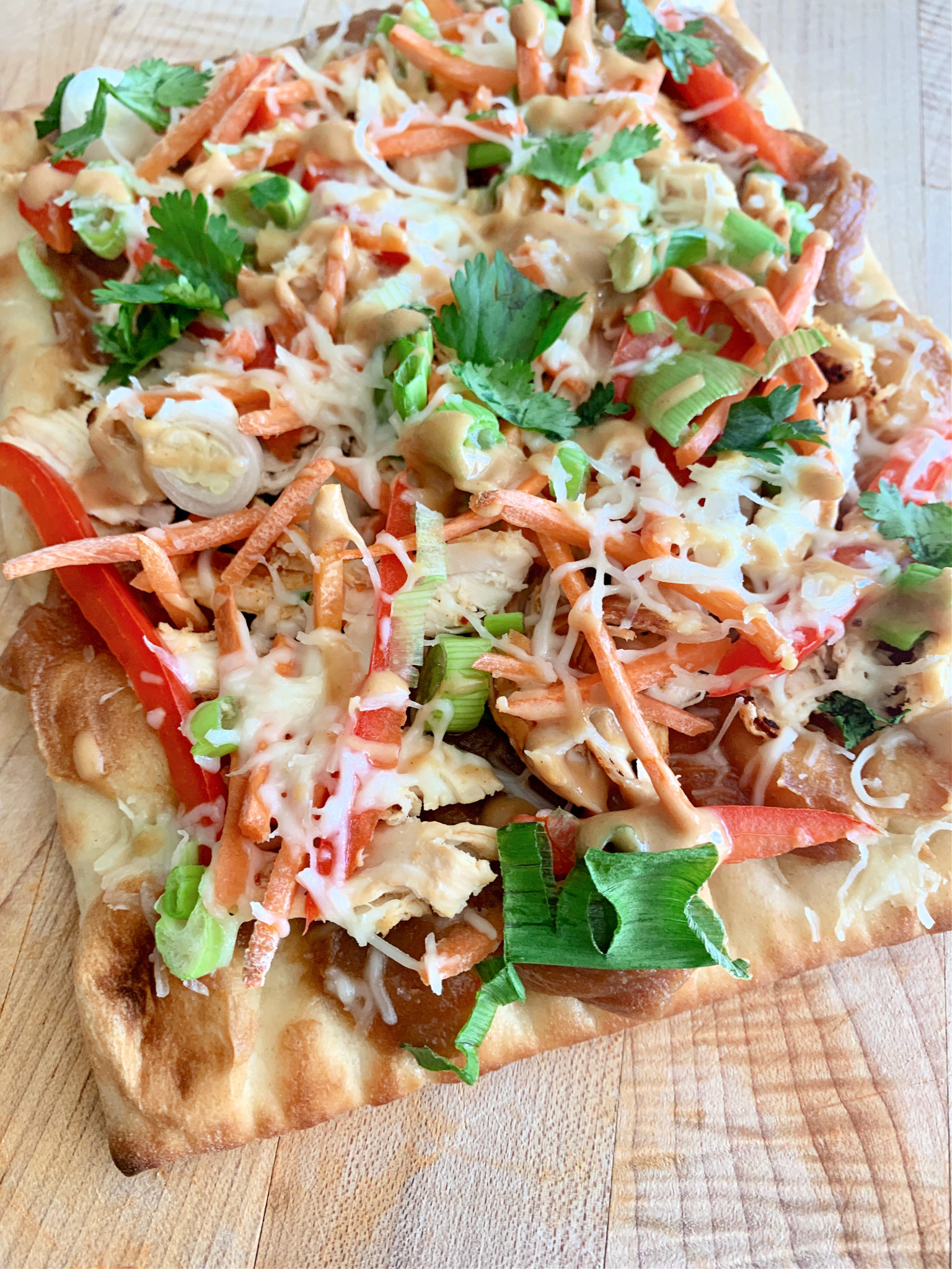 flatbread covered in chicken and veggies and cheese