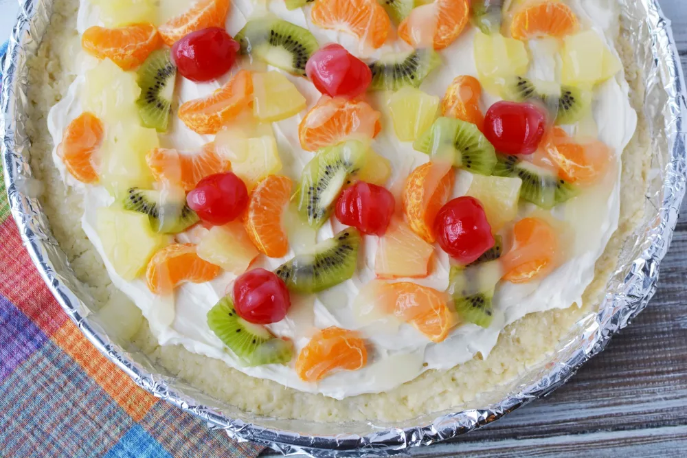 4th of July Fruit Pizza with cherries, pineapple, kiwi and mandarin oranges on a cream cheese filling