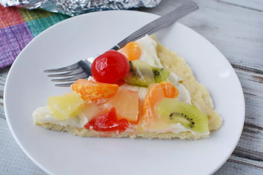 4th of July Fruit Pizza with cherries, pineapple, kiwi and mandarin oranges on a cream cheese filling