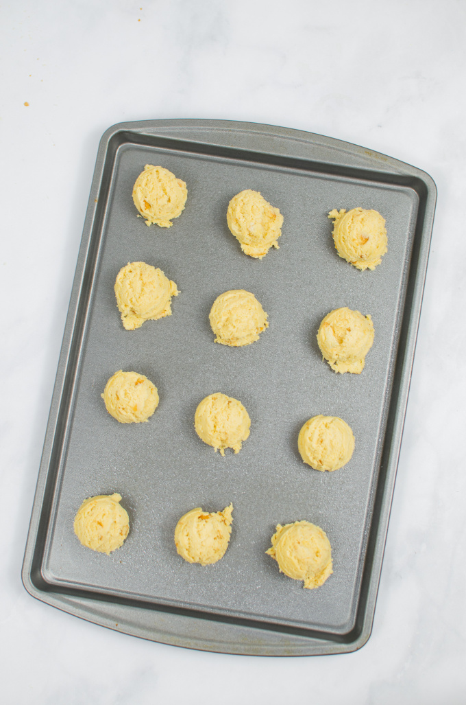 cookie dough scoops on a baking sheet