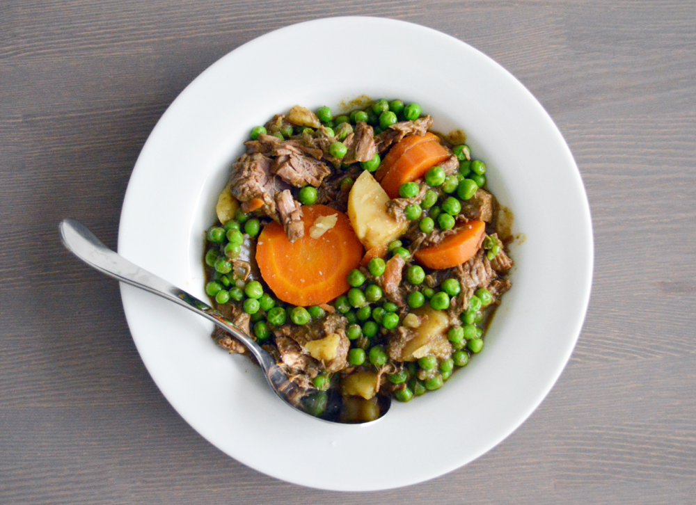 Veggie Beef Stew in a bowl filled with peas and carrots