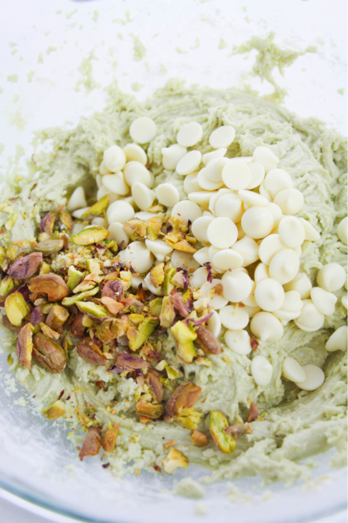 green cookie dough with white chocolate chips and pistachios